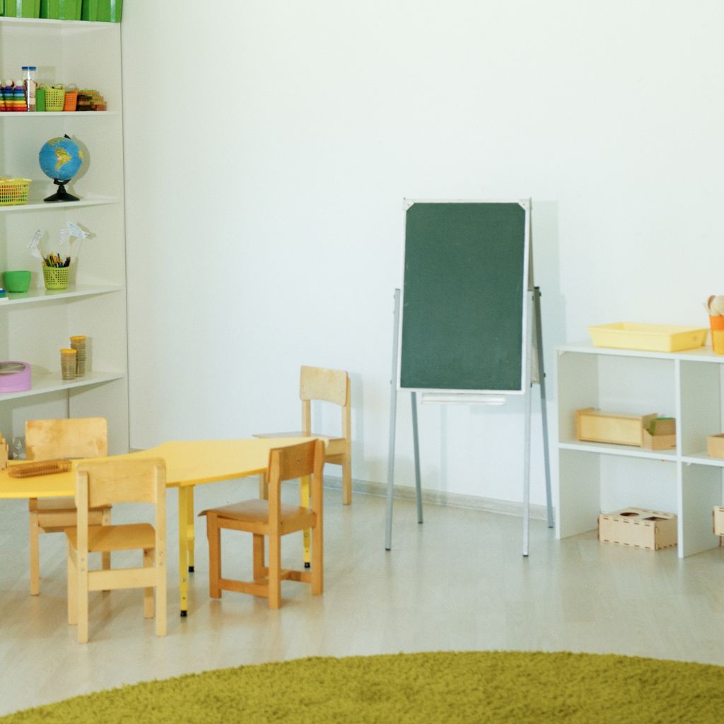 Green chalkboard with movable stand used in a nursery classroom